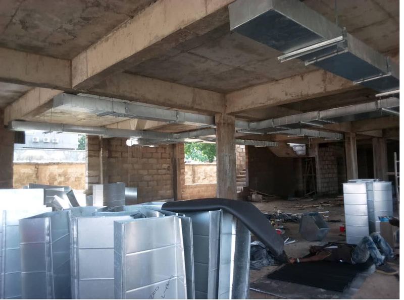 Galvanised ductwork staged beneath the slab