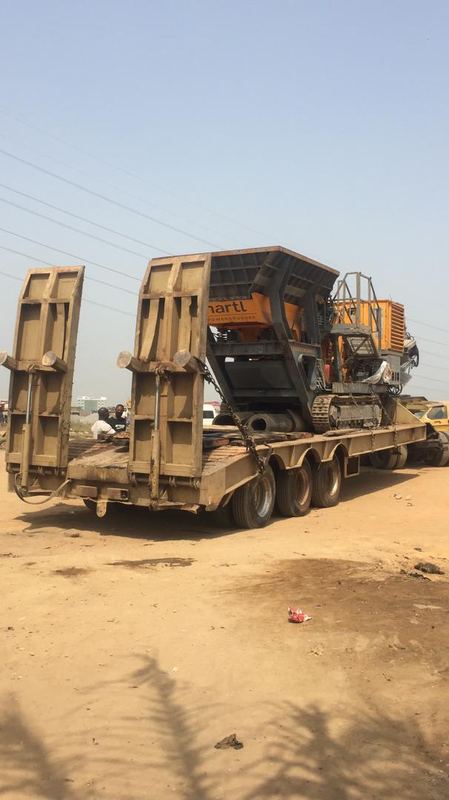 Paver delivered to site on a low-bed trailer